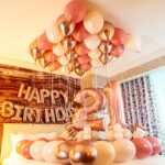 Elegant Rose Gold and Cream Birthday Room Decor with pastel and chrome balloons, rose gold foil banners, and decorative ribbons.