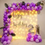 Elegant purple balloon arch for a vibrant birthday celebration.