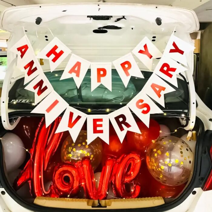 Anniversary Surprise Car Boot Decor with balloons, bunting, and LED lights in a romantic setup.