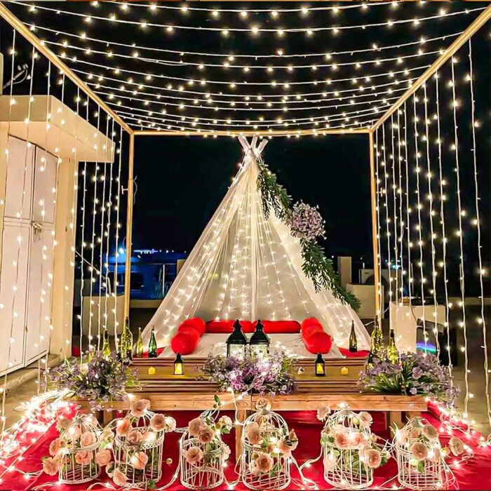 Beautiful outdoor event setup with string lights, eco-friendly decor, and comfortable seating arrangements.