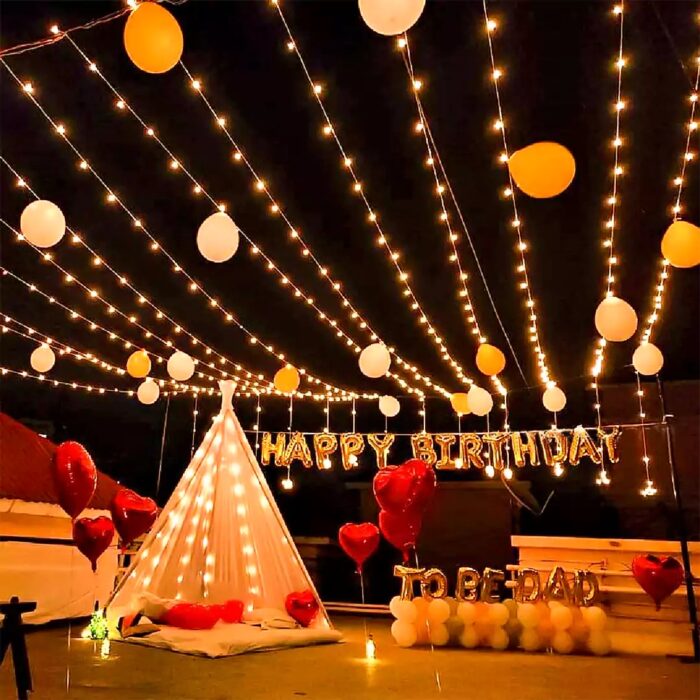 Beautiful outdoor event setup with string lights, eco-friendly decor, and comfortable seating arrangements.